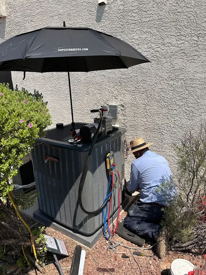 HVAC technician performing outdoor AC maintenance in South Daytona
